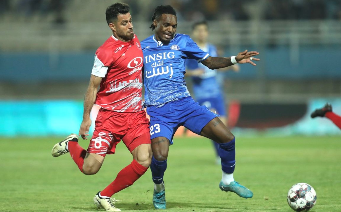 تیوی بیفوما وینگر تیم ملی کنگو و استقلال خوزستان در مصاف با مرتضی پورعلی گنجی مدافع پرسپولیس تهران و تیم ملی ایران در لیگ برتر ایران بازی در اهواز بین پرسپولیس و استقلال خوزستان